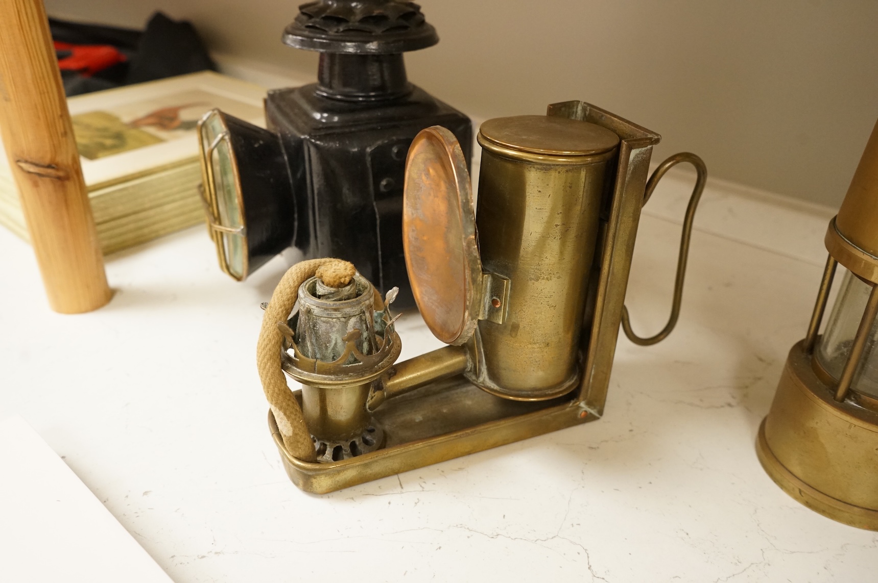 A railway lamp, a vintage Eccles Protector miners lamp and another, largest 17cm high